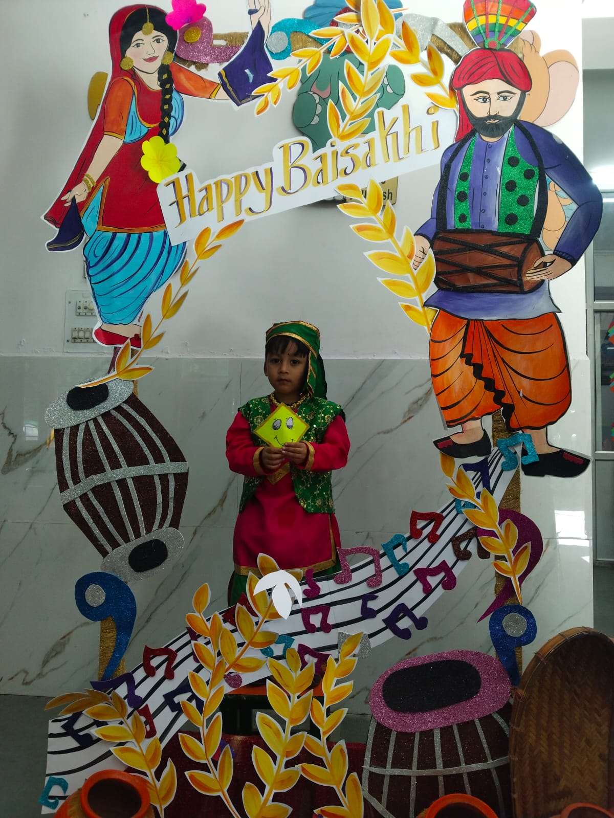 Child posing with Baisakhi prop